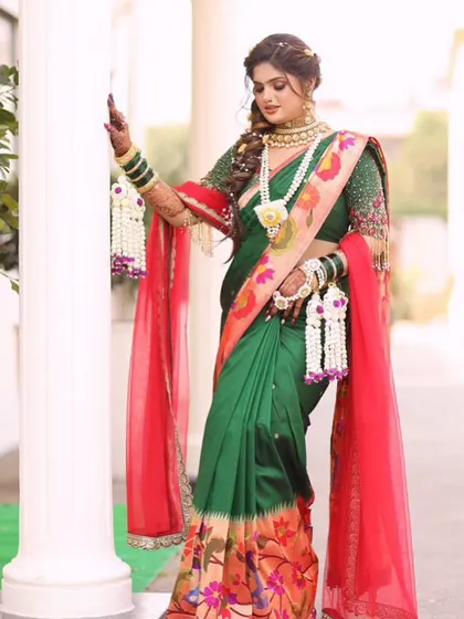 A full-length shot of this stunning bride in her green Paithani, complemented by our fresh white floral jewellery set.