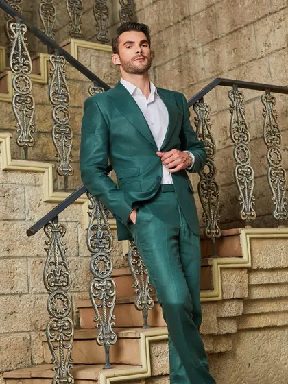 Descending the stairs in style. The green linen suit moves beautifully, showcasing its lightweight fabric and impeccable construction.