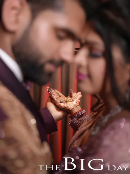 A close-up shot focusing on the couple's hands and the engagement ring, symbolizing the promise of their big day.
