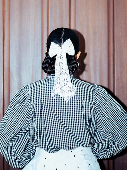The back view of my GQ Christmas look, focusing on the delicate lace bow in my hair.