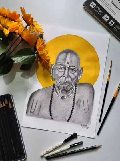 The complete setup with my art supplies next to the finished Swami Samarth sketch. I use professional tools to get the details just right.