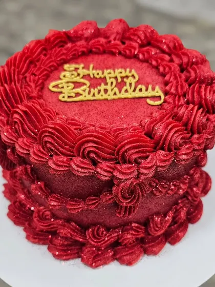 A striking monochrome red vintage cake. I teach how to achieve this vibrant color in buttercream and use different piping tips to create a variety of textures and patterns.