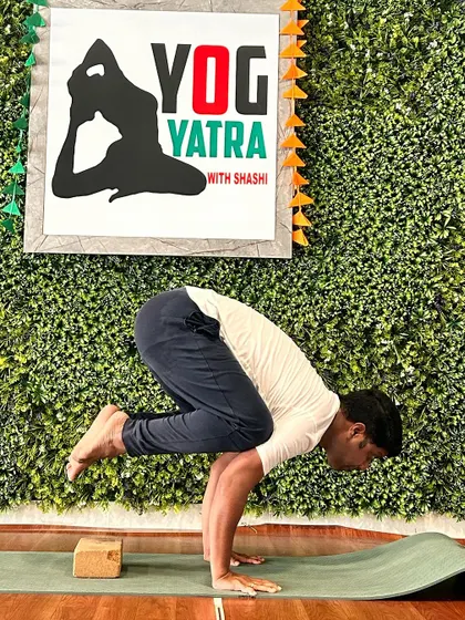 This student is holding a solid Bakasana (Crow Pose). Building the strength for arm balances is a journey, and his consistent practice is clearly paying off.