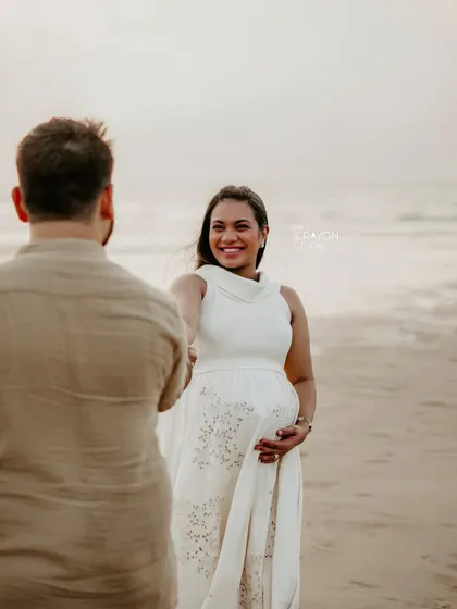 An over the shoulder shot that creates a sense of intimacy and connection. Her bright smile shows the trust and comfort she feels during the session.