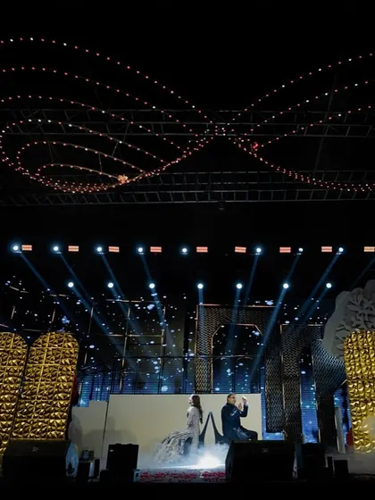 The scale of this sangeet stage was immense. I designed the lighting to include an infinity symbol in the rigging above, while the couple performed on a stage filled with golden lights and fog effects.