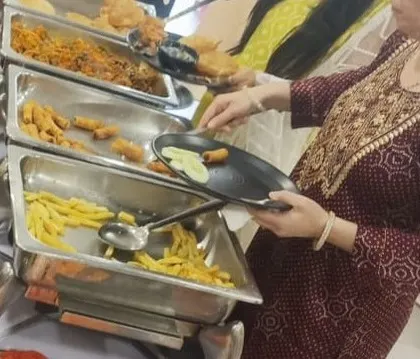A guest enjoying freshly made snacks from our live chaat counter. We love seeing guests delight in our interactive food services.