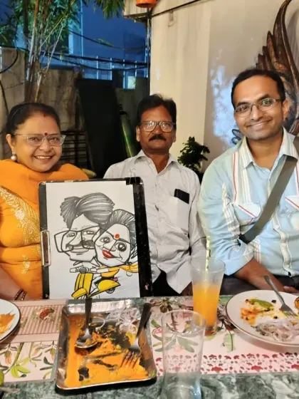 A family enjoying a meal and their new caricature. It's a wonderful souvenir from a family get-together.
