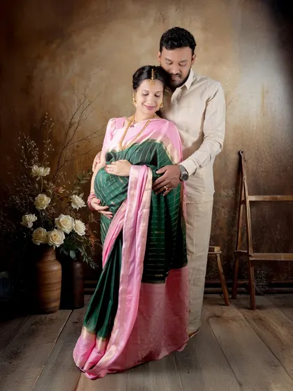 A classic couple's pose against our rustic studio backdrop. The traditional outfits look stunning in this setting.