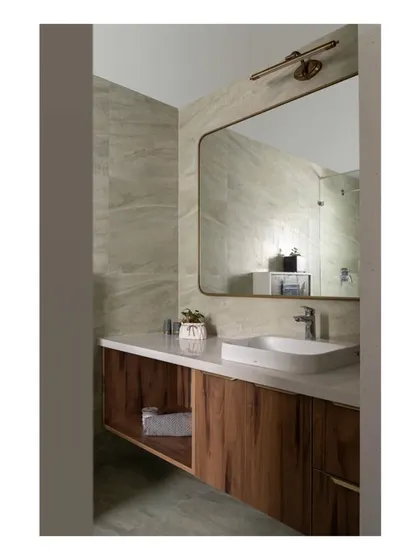 A bathroom transformation in the 'Spanish Country Home,' where dated tiles were replaced with soothing green tones and a functional new layout, creating a fresh and modern space.