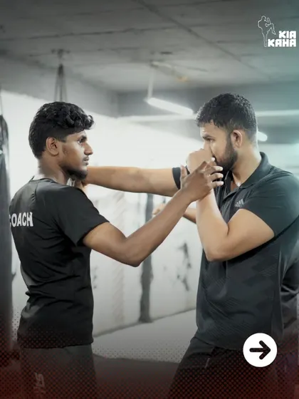 Behind the scenes: a coach gives a student personalized instruction on his boxing form. This attention to detail is what helps our members improve quickly.