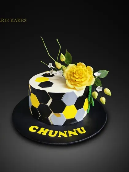 I made this modern cake for my little sister's birthday. It features a geometric honeycomb pattern and is topped with a handmade yellow sugar rose and sweet pea flowers.