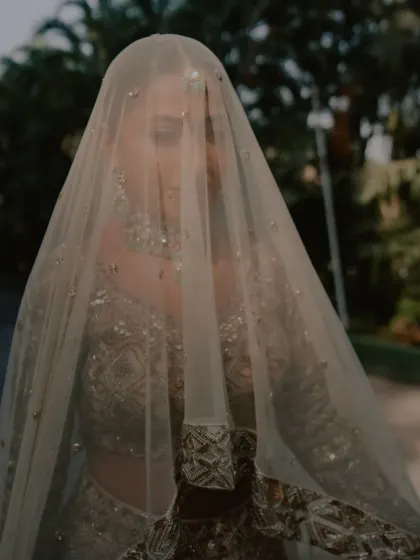 A close-up shot of the bride's face through her veil, creating a soft and romantic effect.