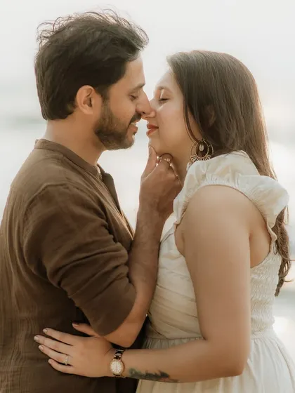 An intimate close-up during a beach pre-wedding shoot. We focus on the gentle touches and loving gazes that tell the story of a couple's affection for one another.