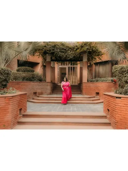 The bride-to-be making her entrance for the haldi ceremony. This shot captures her elegance and the beautiful architecture of the venue.