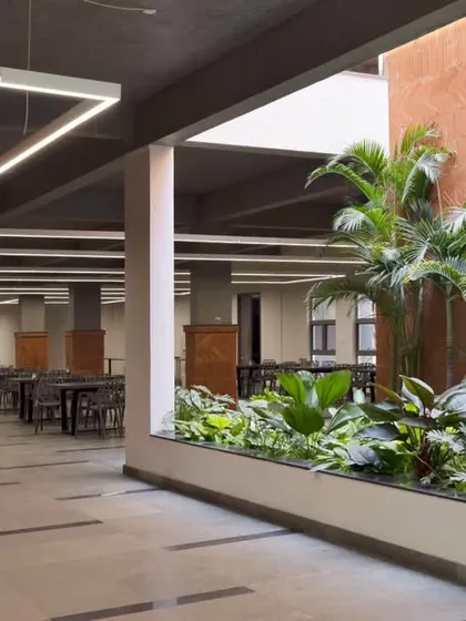 The bright and airy staff canteen at Campus Biovet, dotted with lush green courtyards. This space was designed to provide a refreshing relief for employees during a hectic workday, promoting well-being.