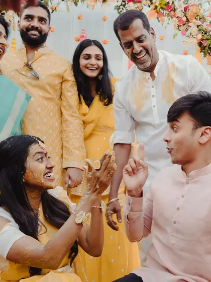A candid shot of the bride sharing a laugh with her family and friends during the fun-filled Haldi ceremony.