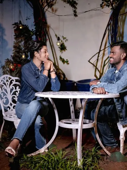 A casual night-time scene at a cafe-style table, with soft lighting creating a relaxed and intimate mood.