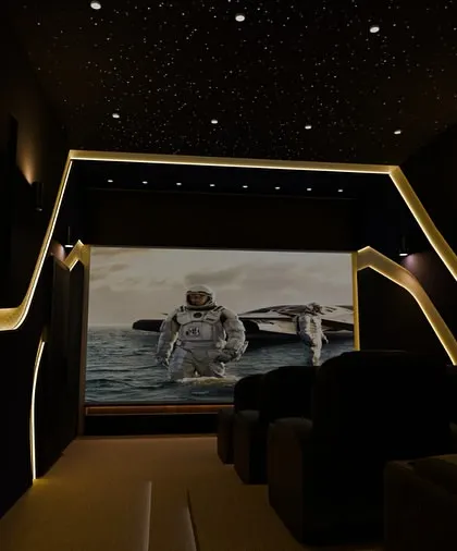 The theater in its element. With the lights dimmed, the screen becomes the absolute focus, while the ambient lighting on the walls prevents eye strain and adds to the immersive atmosphere.