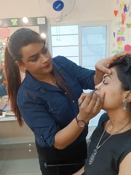 Here I am working closely with a student during a makeup workshop. I believe in providing direct, personal guidance to ensure every student understands the techniques being taught.