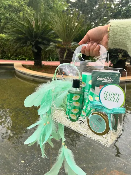 A refreshing green-themed Rakhi hamper with a dreamcatcher. This gift has a calming, bohemian vibe.