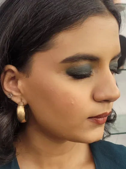 A side view of the formal dark green smokey eye. You can see the seamless blending of the eyeshadow from the lash line up to the crease.
