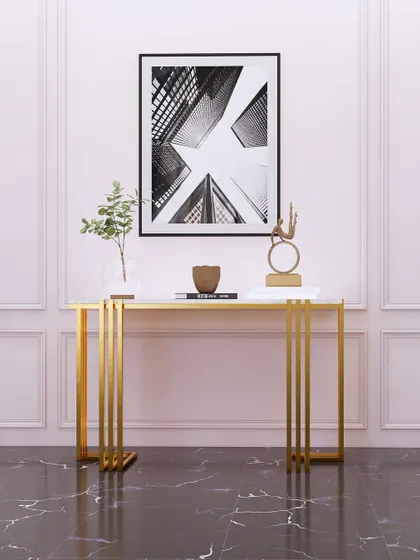 A minimalist console table with a sleek gold frame and marble top, perfect for an elegant entryway.