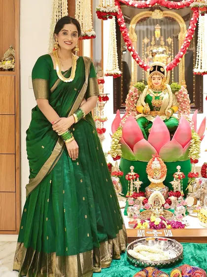 A full view of Raksha in her green half saree, a perfect example of a flawless custom fit.