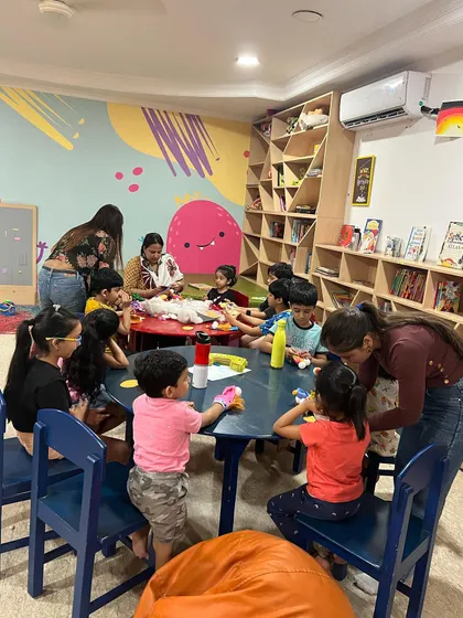 Unlimited drama and fun is our motto. Here, children are gathered around for an interactive session, learning and laughing together.