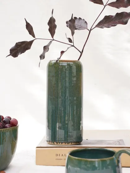 The elegant cylindrical form of this vase is enhanced by the deep, glossy finish of our Lush Green glaze. It's a perfect example of a simple form elevated by a quality glaze.