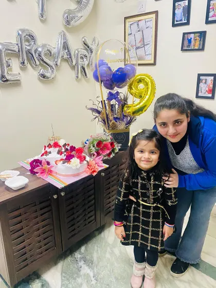 My daughters by the anniversary cake. Involving family in my professional life brings me so much joy.