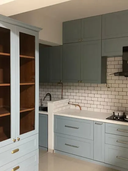 A recipe for perfection: sleek cabinets, subway tiles, and a touch of gold. This pastel blue kitchen is the definition of modern elegance.