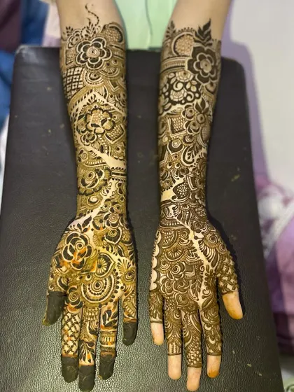 This design features a flowing vine pattern that creates a beautiful negative space element down the center of the arm. It's paired with dense, traditional work on the other arm for a unique asymmetrical look.