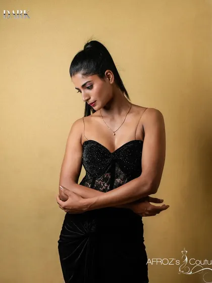 A pensive pose in the black corset gown, showing its versatility for both powerful and soft looks.
