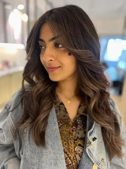 Another view of this beautiful warm-toned balayage. The face-framing layers and soft waves create a stunning, effortless style.