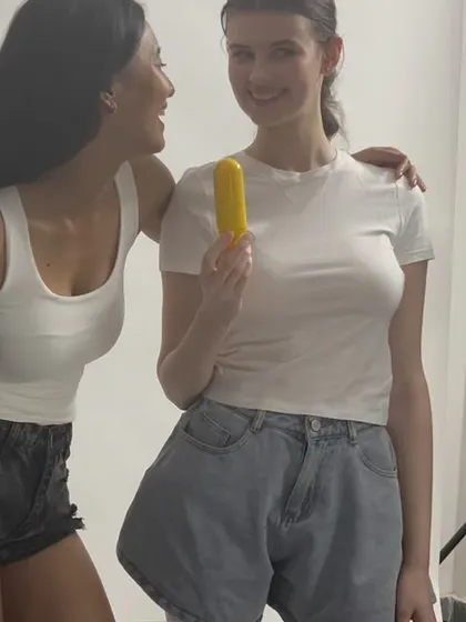A candid and happy moment between two models on set during a skincare shoot.