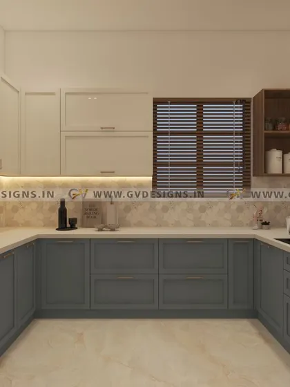 This U-shaped kitchen features a classic duco finish in a sophisticated grey-blue. The design includes wall units with traditional glass shutters, an open spice rack for easy access, and a breakfast counter opposite the cooking zone.
