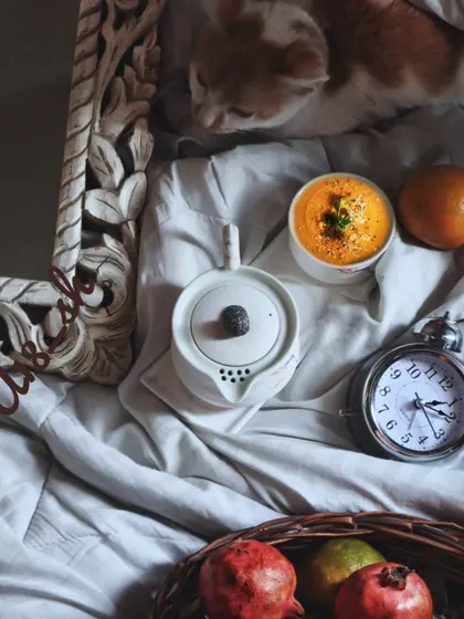 Another angle of the cozy flatlay, this time with a vintage clock and a carved mirror. The composition tells a story and creates a specific, gentle mood.