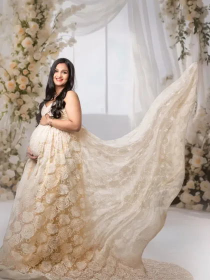 A dynamic shot capturing the flowing train of a beautiful lace gown, adding a sense of movement and grandeur to the portrait.