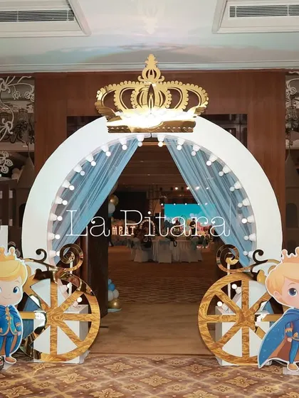 The grand entrance to a Prince-themed birthday party. A royal archway topped with a golden crown and flanked by castle turrets and cute prince cutouts set a majestic tone for the celebration.