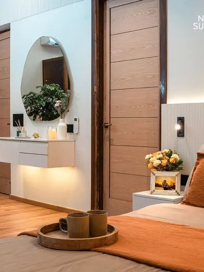 This shot highlights the floating vanity and fluted headboard detail in the eco-chic bedroom. The design uses clean lines, hidden lighting, and a mix of textures to create a space that is both modern and calming.