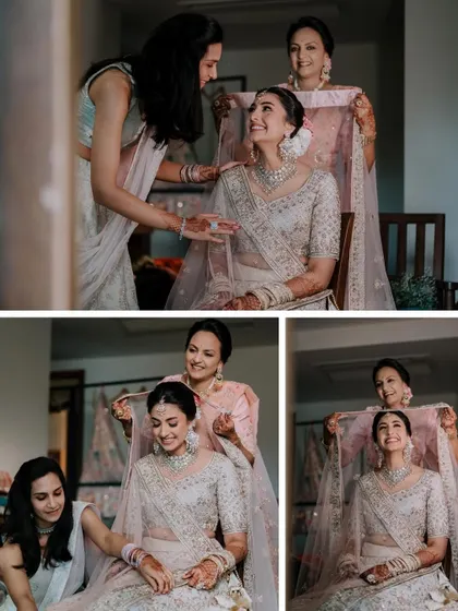 A beautiful moment of the bride getting ready with her mother and sister, who are helping her with her veil.