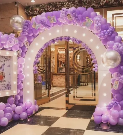 Make a grand entrance for your little one's party. We created this stunning balloon archway decorated with butterflies and a personalized welcome sign for a magical start to the celebration.
