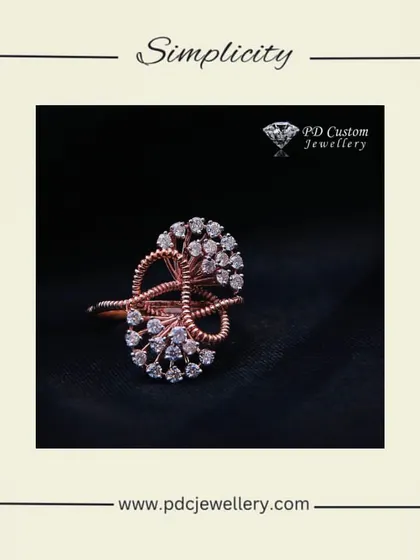 Simplicity at its finest. This elegant cocktail ring is crafted in 14kt hallmarked rose gold, featuring an intricate, swirling design studded with natural diamonds.