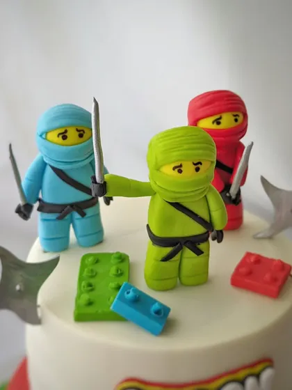 A detailed shot of the three Lego ninja figures, complete with their swords and stars. Each one is carefully crafted to bring the characters to life.