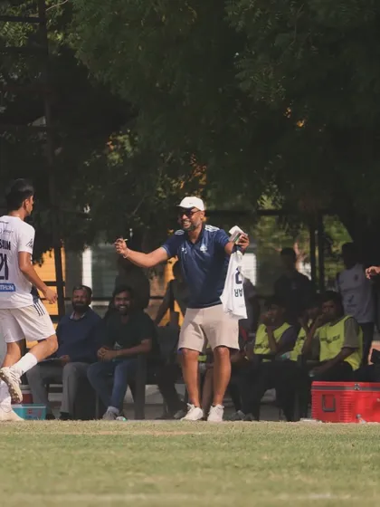 The passion of our coaching staff is evident on the sidelines, celebrating a goal and motivating the team.