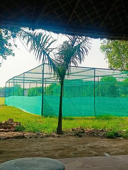 A view of our four dedicated practice nets with turf wickets. This is where the hard work happens, allowing multiple players to work on their batting and bowling skills simultaneously.