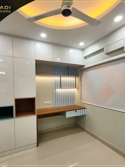 A multi-functional bedroom unit combining a wardrobe with a built-in study desk. The high-gloss white finish and clever use of colored niches make it perfect for a modern kid's room.