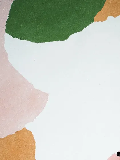 A close-up of the custom multi-color concrete slab, showing the soft, matte texture and the subtle blending of earthy pink, green, and ochre tones.
