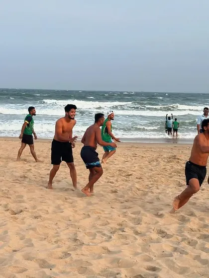 Players enjoying a game of football on the beach. These activities help build camaraderie and keep the players refreshed during a long tournament.