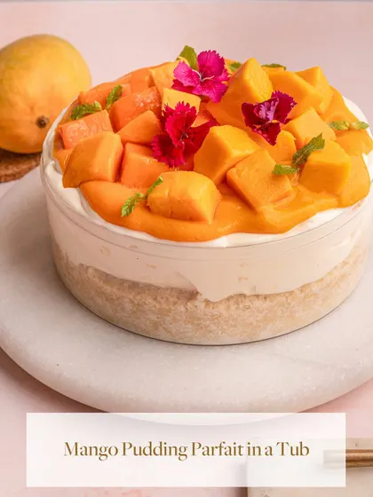My Mango Pudding Parfait in a Tub, a star of my seasonal mango collection. It's layered with vanilla sponge, vanilla pudding, and topped with fresh Alphonso mangoes and edible flowers.